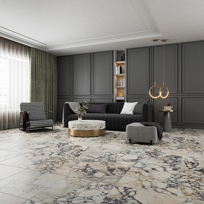 Living room interior featuring Fitzrovia Picasso 30.5 x 61cm honed natural marble tiles across the floor, showcasing a light base with dramatic, multi-tonal veining, styled with deep grey cabinetry, soft furnishings, and warm metallic accents for a refined, contemporary setting.