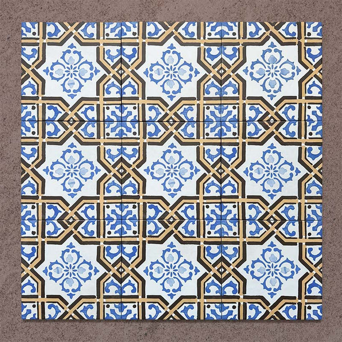 Grouped layout of Carnaby Maestro Victorian-style 20x20cm porcelain wall and floor tiles, showing the full repeating intricate blue floral motif framed by mustard and black geometric borders on an aged white background.