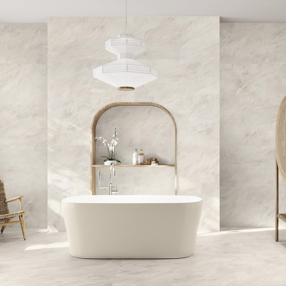 Bathroom interior featuring Grand Mahal Matt Marble effect 60 × 120cm porcelain wall and floor tiles, showcasing a soft ivory base with subtle beige and warm undertones, paired with a freestanding bath, light wood accents, and minimalist styling for a calm, spa-like finish.