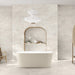 Bathroom interior featuring Grand Mahal Matt Marble effect 60 × 120cm porcelain wall and floor tiles, showcasing a soft ivory base with subtle beige and warm undertones, paired with a freestanding bath, light wood accents, and minimalist styling for a calm, spa-like finish.
