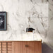 Interior detail featuring Maine Calacatta Matt Marble 60 × 60cm porcelain wall tiles, showcasing a crisp white base with fine grey veining, paired with warm wood cabinetry and soft lighting to create a balanced, contemporary contrast.