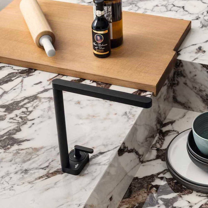 Close-up of Maine Capraia Matt Marble 60 × 60cm porcelain tiles, highlighting a crisp white base with bold, expressive dark veining, styled with warm wood and matte black fixtures to emphasise contrast and a refined marble effect.