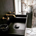 Bathroom interior featuring Maine Capraia Matt Marble 60 × 60cm porcelain wall and floor tiles, styled with bold dark veining against a soft white base, paired with black fixtures and warm brass accents for a striking, contemporary contrast.