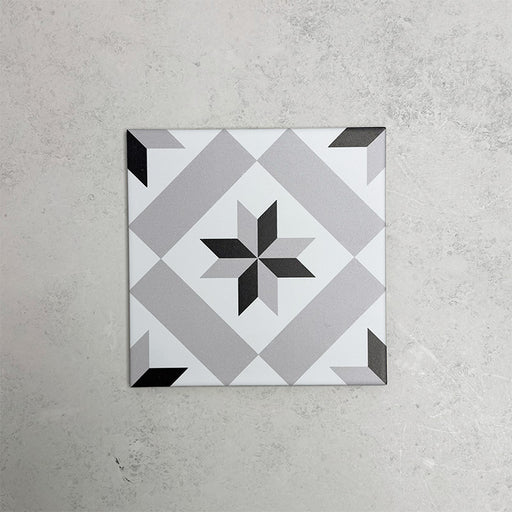 Georgetown Star Victorian-style 20x20cm patterned porcelain tile, featuring a classic black, white, and grey star motif with geometric detailing.