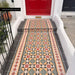 Victorian-style entrance pathway featuring Maison Norton Decor 20cm x 20cm patterned wall and floor tiles, arranged with decorative border tiles to create a colourful geometric walkway leading to a bright red front door.