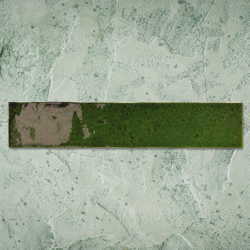 Single Malaga Tourmaline Green Brick 6.5 × 32.8cm gloss ceramic wall tile, showcasing rich green tonal variation, a reflective handcrafted-style finish, and softly weathered detailing for added depth and character.