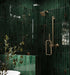 Walk-in shower featuring Maldives Pine Green 5 × 40cm gloss ceramic wall tiles, laid vertically with rich green tonal variation, paired with brass shower fittings, glass enclosure, and a built-in tiled bench for a cohesive finish.