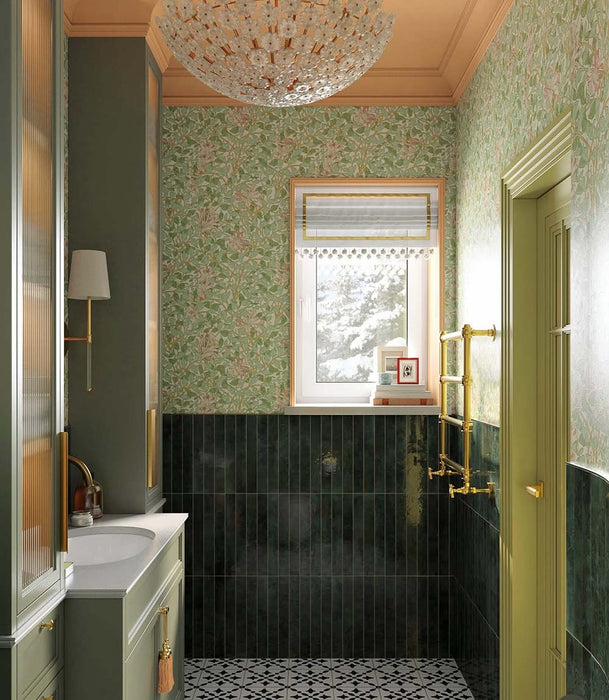 Bathroom interior featuring Maldives Pine Green 5 × 40cm gloss ceramic wall tiles, laid vertically across the lower walls with deep green tonal variation, paired with brass fixtures, patterned floor tiles, and soft green joinery for a cohesive, classic finish.