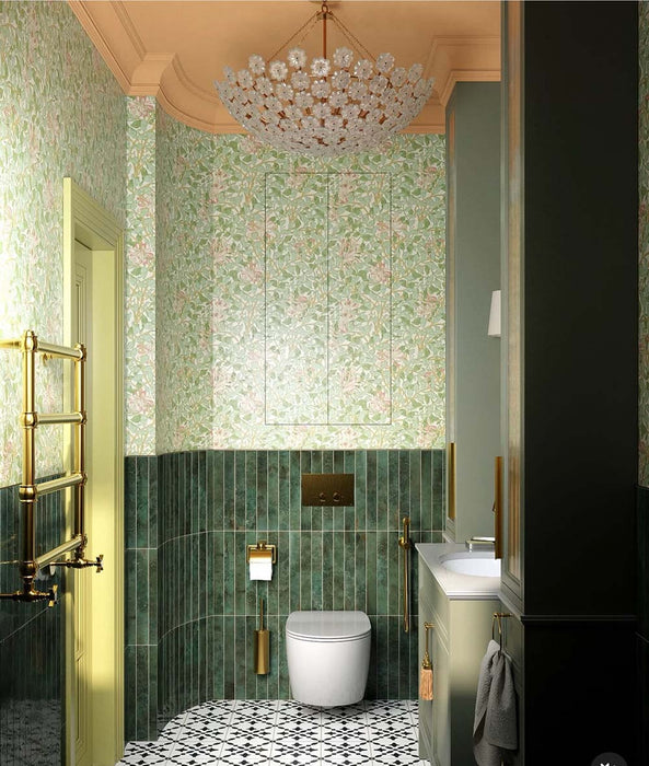 Bathroom interior featuring Maldives Pine Green 5 × 40cm gloss ceramic wall tiles, laid vertically across the lower walls with rich green tonal variation, paired with brass fittings, patterned floor tiles, and soft green panelling for a refined, layered look.