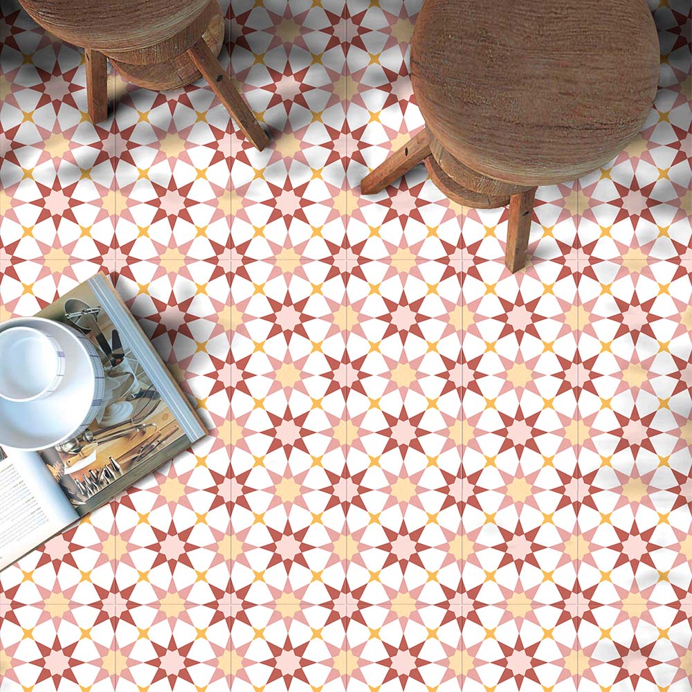 Café-style setting featuring Agraba Springs 20x20cm Moroccan-style ceramic floor tiles in warm terracotta, peach, and white tones, styled with wooden stools and an open magazine for a relaxed Mediterranean feel.
