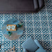 Marketing setting featuring Soukaina Blue C Moroccan-style 20cm x 20cm patterned porcelain floor tiles, showcasing an all-over geometric star pattern in rich blue and white tones with a matt finish, styled in a contemporary living space.