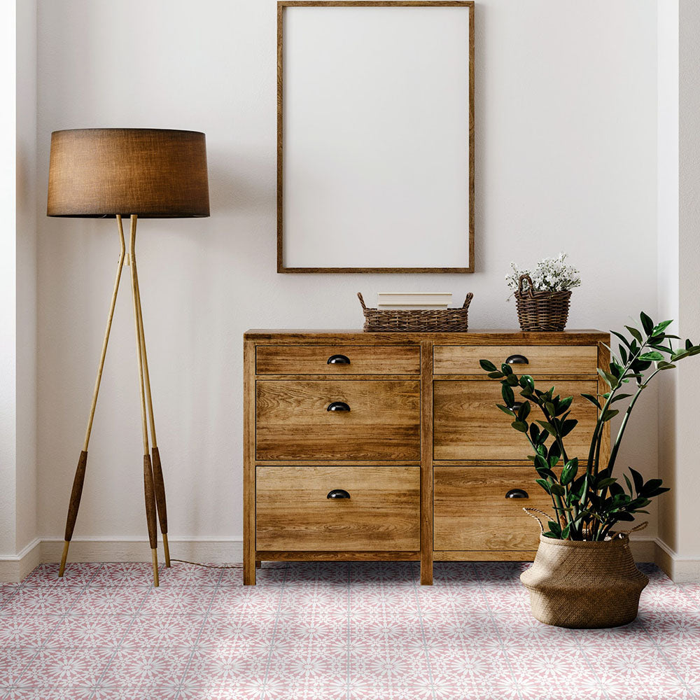 Interior setting featuring Fizaan Pink Rose 20x20cm Moroccan-style porcelain floor tiles, showcasing a delicate geometric pattern in soft pink and neutral tones, styled with warm wooden furniture and greenery.