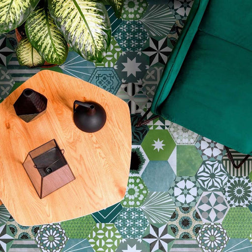 Marketing image featuring Fihrdos Verde Hexagon Patchwork Moroccan-style 18.7x21.6cm patterned porcelain floor tiles, showcasing a mix of green-toned geometric designs styled with contemporary furniture and plants.