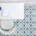 Marketing setting featuring Soukaina Blue A Moroccan-style 20cm x 20cm patterned porcelain floor tiles, showcasing a geometric star design in blue, white and soft neutral tones with a matt finish, styled beneath a modern workspace.
