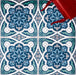 Overhead view of Europa Bucharest 20x20cm Victorian Moroccan style floor tiles in blue, teal and white tones, forming an ornate geometric pattern, styled with a red chair leg in a decorative interior setting.