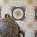 Kitchen wall featuring Cabana La Calle 20x20cm Moroccan-style ceramic tiles in a mosaic-effect circular pattern, styled with a leopard-print wooden chopping board.