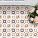 Cabana Manzanillo 20x20cm Moroccan-style porcelain tiles in a geometric star pattern featuring blush pink, mustard, terracotta, lilac, and turquoise tones with a matt finish, styled in a bright floral interior setting.
