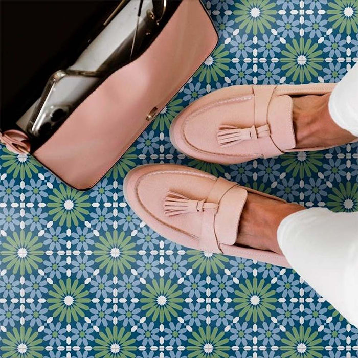 Floor styled with Fizaan Springs Mini Moroccan-style 15×15cm porcelain tiles, featuring a blue and green geometric pattern paired with blush pink accessories.