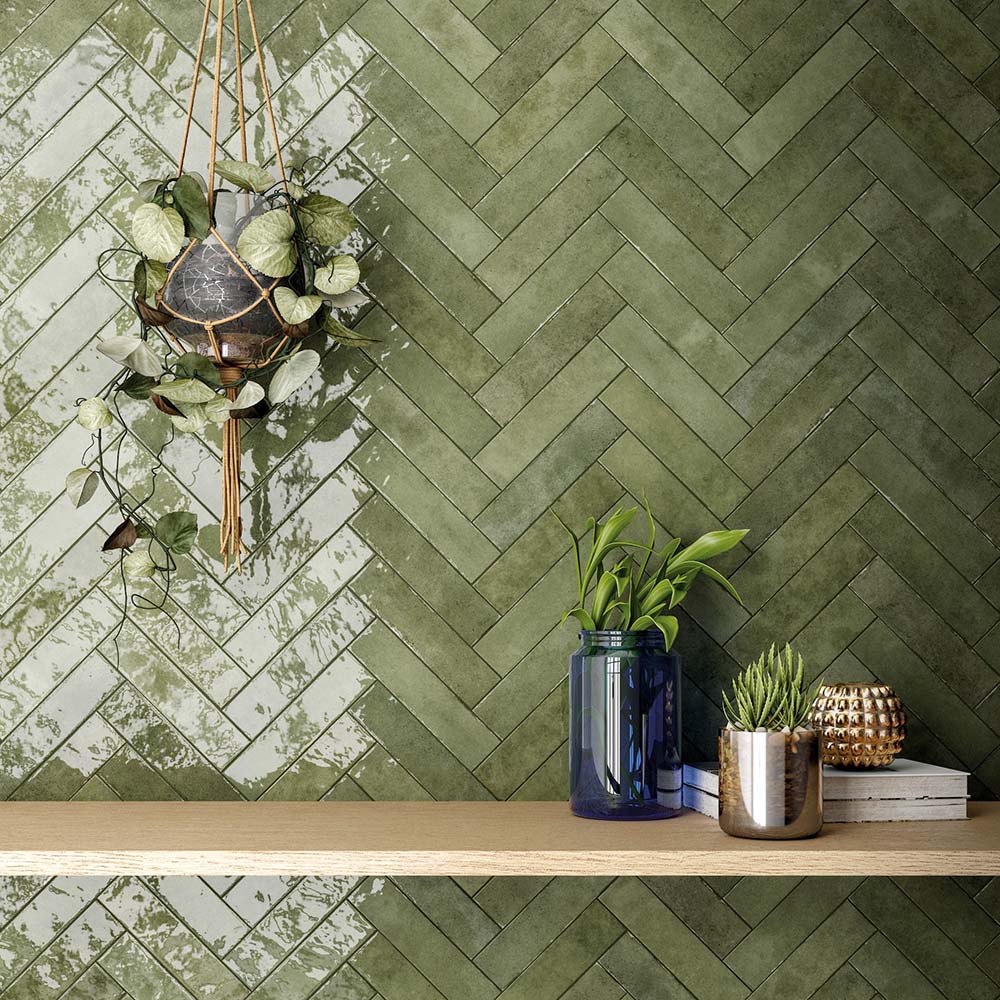 Madison Sage Green Brick Wall Tiles 6x24.6cm — marketing setting highlighting the organic charm of these earthy green tones. The glossy, handcrafted finish and herringbone layout bring depth and natural warmth to any interior, creating a calm and contemporary statement wall perfect for kitchens, bathrooms, or feature spaces.