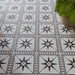 Galata White Moroccan style 20x20cm patterned tiles, used as a floor installation to create a crisp white and black geometric star feature.