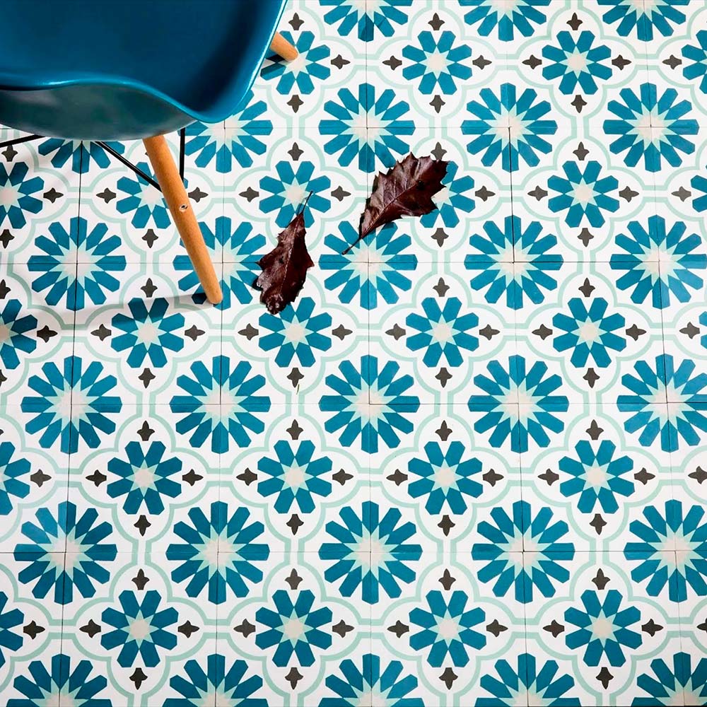 Room setting featuring Clarence House Teal Green 20x20cm Victorian Moroccan-style porcelain floor tiles, styled with a teal chair and natural lighting to highlight the intricate geometric pattern.
