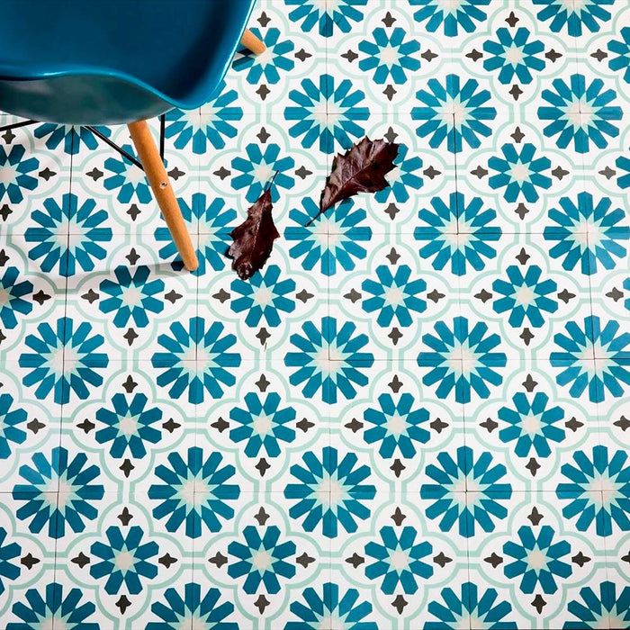 Room setting featuring Clarence House Teal Green 20x20cm Victorian Moroccan-style porcelain floor tiles, styled with a teal chair and natural lighting to highlight the intricate geometric pattern.