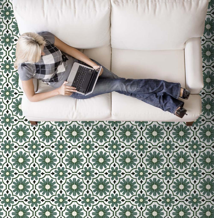Living room featuring Clarence House Verde Green 20x20cm Victorian Moroccan-style porcelain floor tiles, styled with a white sofa and neutral décor to highlight the bold green and white geometric pattern.
