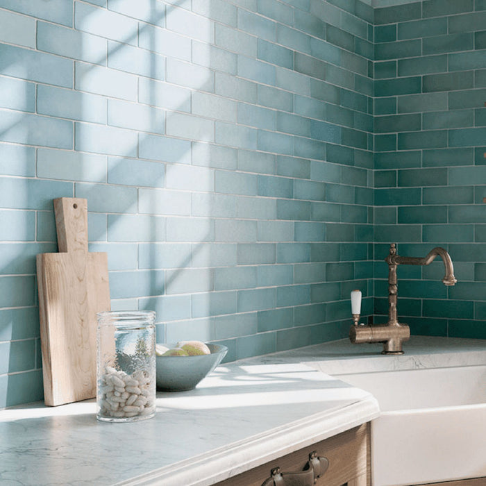 Zellij Aqua Blue brick tiles, 6.5cm x 20cm, Moroccan style, soft aqua blue tones with natural tonal variation, glossy glazed finish, installed in a horizontal brick layout, styled in a bright and airy kitchen marketing setting.