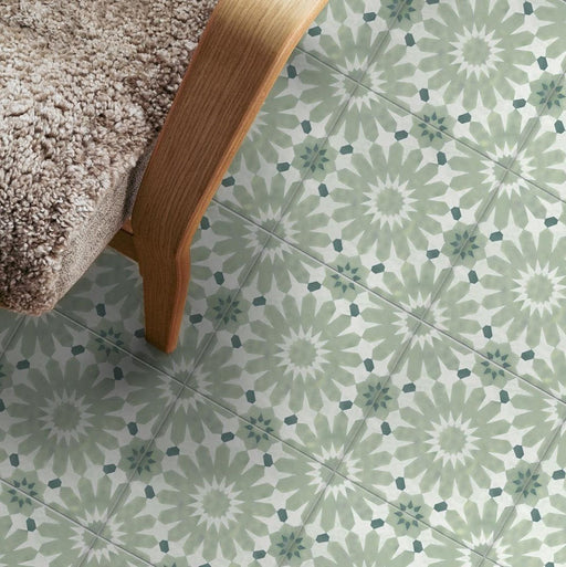 Floor styled with Fizaan Jade Green Moroccan-style 20×20cm porcelain tiles, featuring a soft green geometric star pattern paired with wooden furniture and neutral textures.