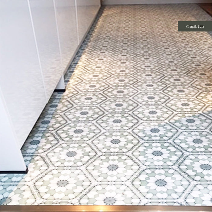 Customer kitchen featuring Maroush Green 18.7x21.6cm Moroccan-style hexagon floor tiles, with intricate sage green, white and grey floral geometric motifs arranged in a repeating pattern, paired with white cabinetry.