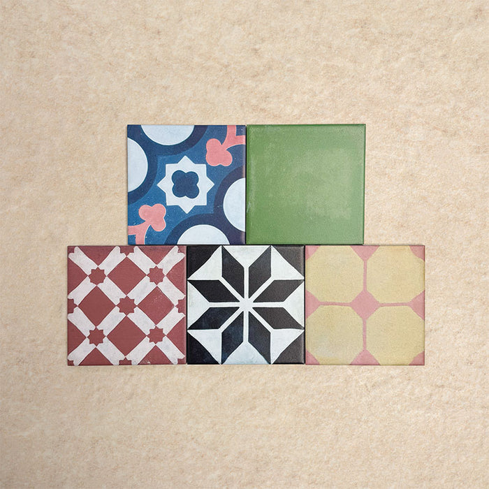 Fihrdos Mini Patchwork Moroccan-style 15x15cm patterned porcelain tiles arranged in a grouped layout, showcasing a mix of colourful geometric and traditional decorative designs.