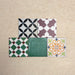 Fihrdos Mini Patchwork Moroccan-style 15x15cm patterned porcelain tiles arranged in a grouped layout, showcasing a mix of colourful geometric and traditional decorative designs.