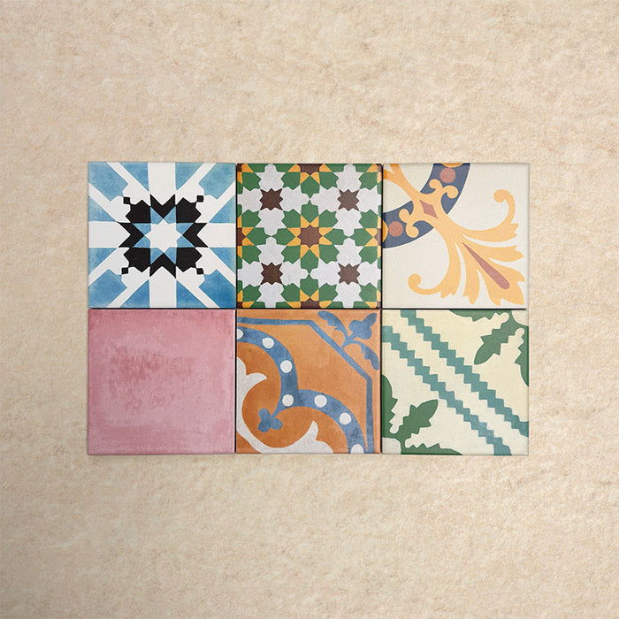 Fihrdos Mini Patchwork Moroccan-style 15x15cm patterned porcelain tiles arranged in a grouped layout, showcasing a mix of colourful geometric and traditional decorative designs.