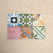 Fihrdos Mini Patchwork Moroccan-style 15x15cm patterned porcelain tiles arranged in a grouped layout, showcasing a mix of colourful geometric and traditional decorative designs.