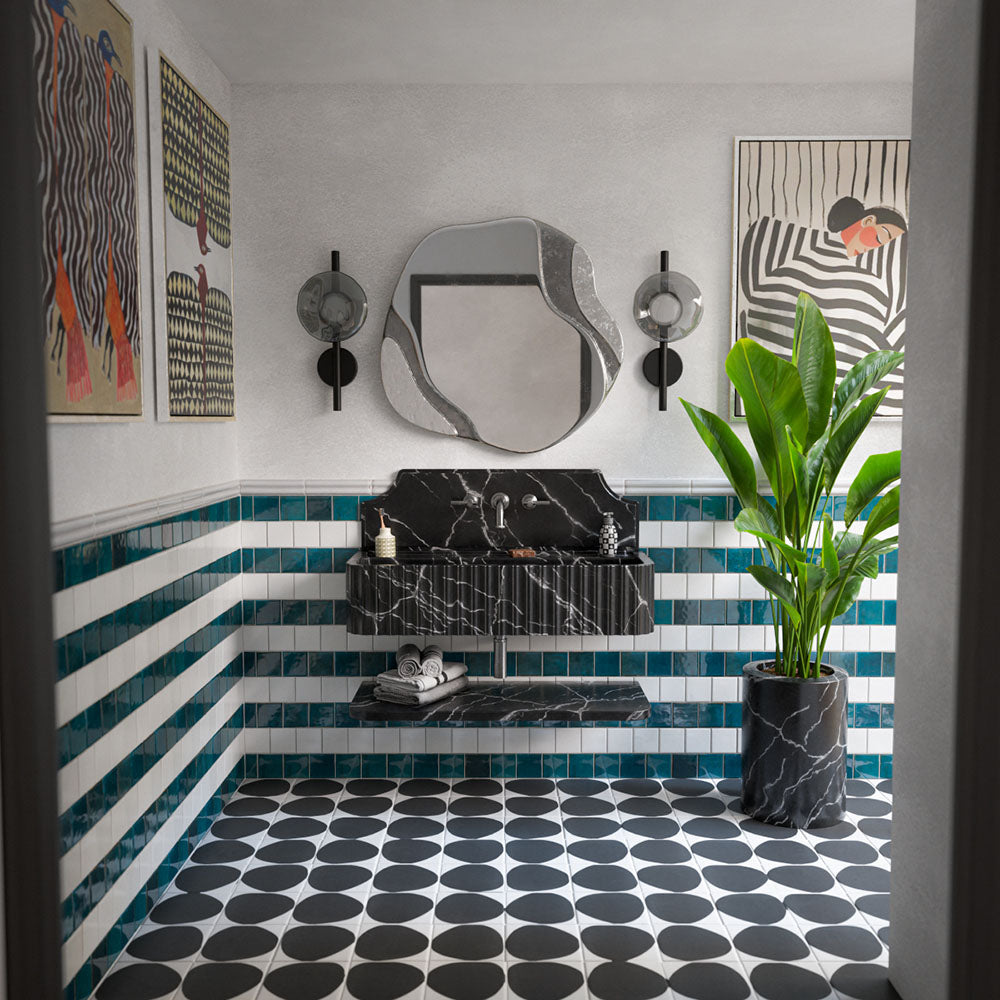Eclectic bathroom featuring Mizu Antique White Square 10cm x 10cm gloss porcelain wall tiles, paired with blue square tiles in a striped design, black and white patterned floor tiles and a statement marble effect basin.