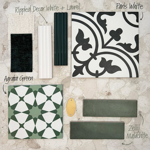 Interior moodboard featuring the Agraba Green 20x20cm Moroccan-style tile paired with Paris White, Zellij Malachite, and Rippled Décor White and Laurel tiles, styled with fabric and brass samples on a neutral stone background for design inspiration.