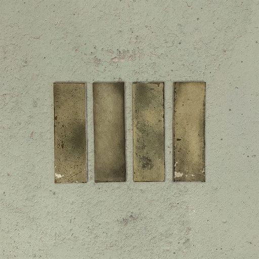 Close-up of Fusion Bricks Moss Green 6.5x20cm brick wall tiles, showcasing earthy green tones with subtle tonal variation and a lightly textured surface, highlighting a natural, handcrafted appearance.