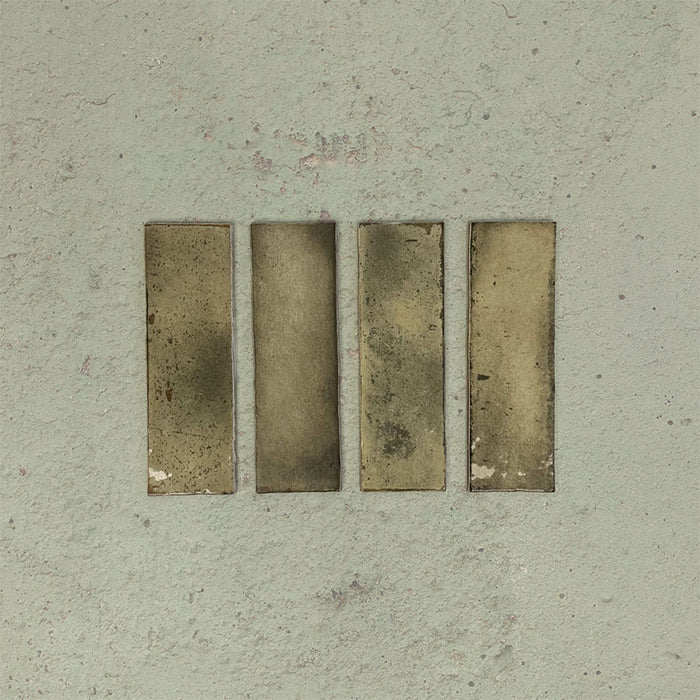 Close-up of Fusion Bricks Moss Green 6.5x20cm brick wall tiles, showcasing earthy green tones with subtle tonal variation and a lightly textured surface, highlighting a natural, handcrafted appearance.