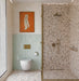 Normandie Mint Green 7.5cm x 15cm rustic effect gloss wall tiles, bringing soft mint green tones and subtle surface texture to the bathroom walls, paired with terrazzo effect tiles, brushed brass fittings and warm neutral finishes.
