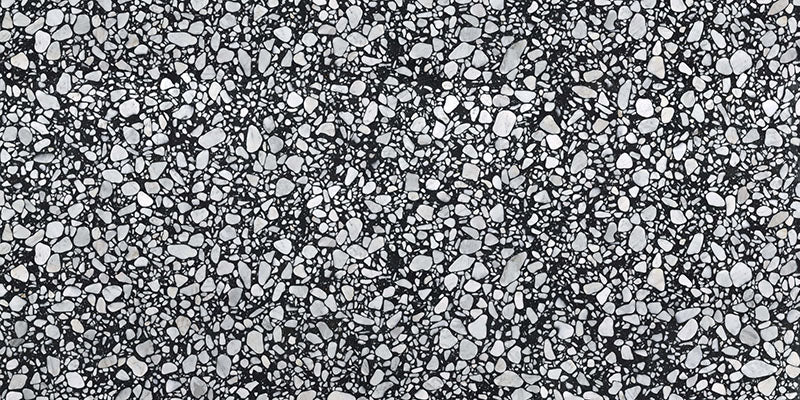Noventa Terrazzo Nero 59x118cm matt porcelain tile, featuring a bold black terrazzo effect surface with contrasting white and grey stone fragments in a contemporary large-format design for walls and floors.
