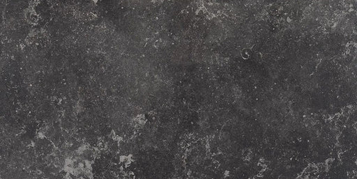 Modern bathroom featuring Obsidian Stone Nite 30x60cm stone-effect porcelain wall and floor tiles in deep charcoal tones, styled with a freestanding bath, black accents, textured mosaics and minimalist contemporary décor.