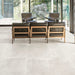 Living room featuring Obsidian Stone Silk 60x60cm stone-effect porcelain floor tiles in soft light grey tones, styled with modern leather seating, large glazing and minimalist contemporary interiors filled with natural light.