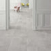 Interior hallway featuring Obsidian Stone Silver 30x60cm stone-effect porcelain floor tiles in soft silver-grey tones, styled with classic wall panelling, pastel accent chairs and elegant contemporary interiors with natural light.