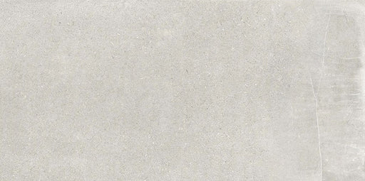 Product display of Obsidian Stone Silver 30x60cm stone-effect porcelain tiles in soft silver-grey tones, featuring subtle veining, textured detailing and a realistic natural stone appearance with a matt finish.