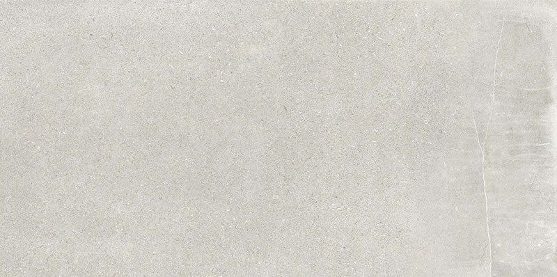 Product display of Obsidian Stone Silver 30x60cm stone-effect porcelain tiles in soft silver-grey tones, featuring subtle veining, textured detailing and a realistic natural stone appearance with a matt finish.