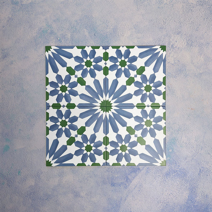Arrangement of Fizaan Ocean 20x20cm Moroccan-style porcelain tiles, showcasing a repeating geometric pattern in blue, green and white tones.