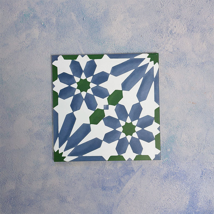 Single Fizaan Ocean 20x20cm Moroccan-style porcelain tile featuring a bold geometric pattern in blue, green and white tones.
