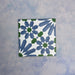 Single Fizaan Ocean 20x20cm Moroccan-style porcelain tile featuring a bold geometric pattern in blue, green and white tones.