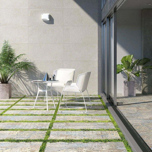Outdoor patio featuring Boheme Ocean Blend 2cm 50 × 100cm patterned porcelain slabs, laid with grass joints to soften the look. Subtle blue and beige aged-effect tones create a relaxed, natural feel, ideal for contemporary outdoor spaces.
