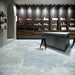 Interior featuring Boheme Ocean Blue 60 × 60cm patterned floor tiles, blending soft blue and muted tones with a worn, decorative effect. Ideal for adding character to contemporary spaces such as retail interiors, kitchens, or open-plan living areas.